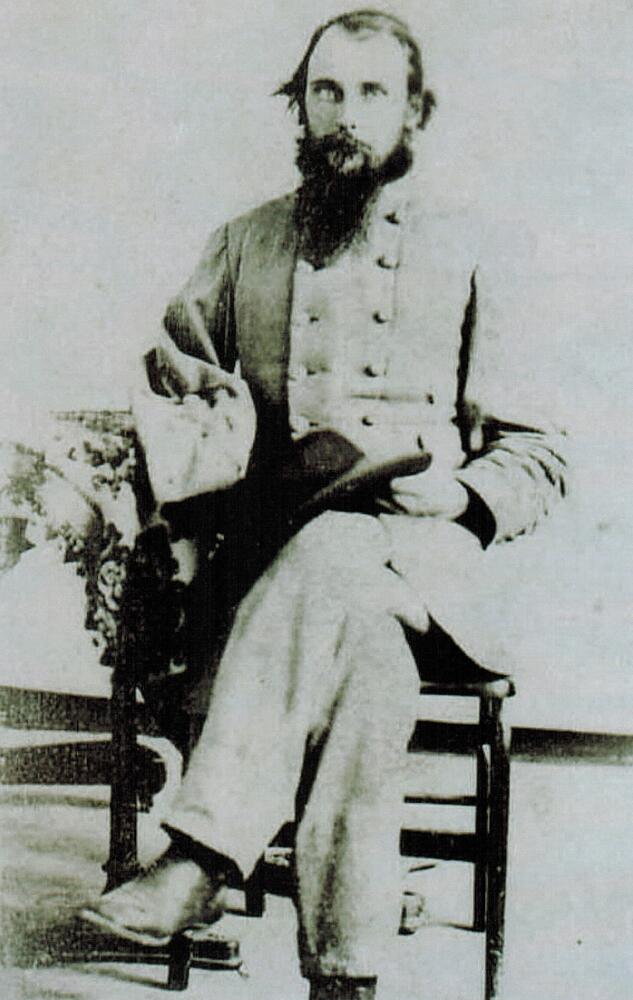 A black and white image of George W. Law.  Law is seated and wearing a gray Confederate Uniform.