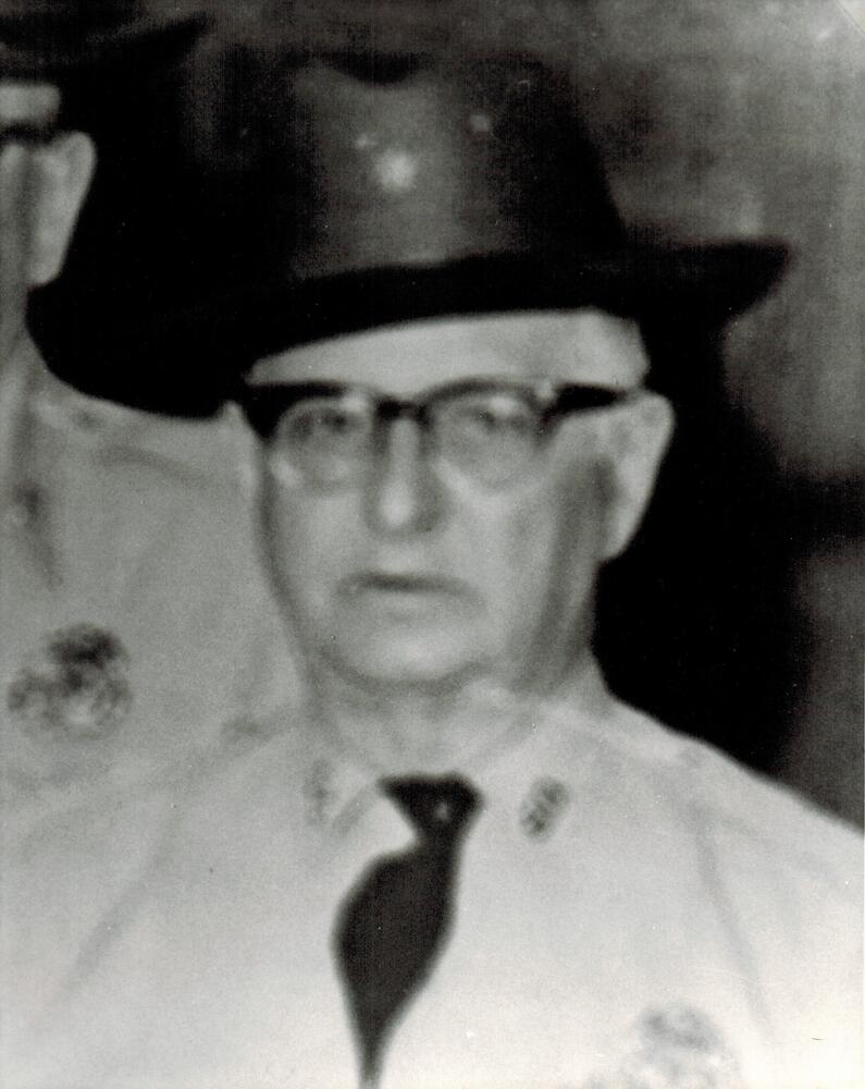 A black and white image of Willis Hidelbaugh wearing a Sheriff's Office uniform.
