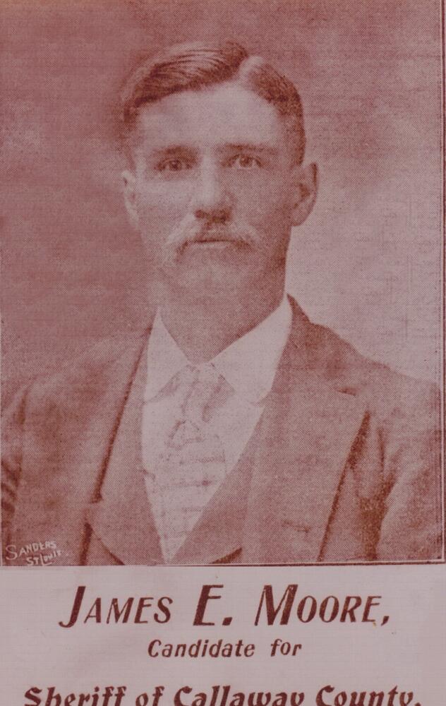 A sepia toned image of James E. Moore wearing a three piece suit.  The words James E Moore, Candidate for Sheriff of Callaway County appear below the image.  There is a printer's mark, 