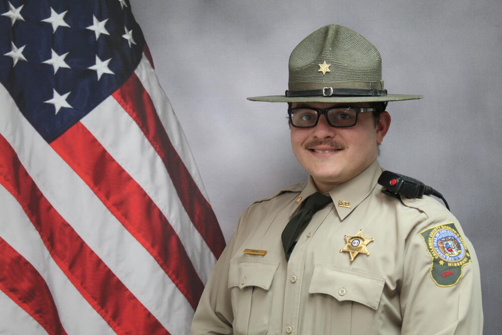 Deputy Matt Frank pictured in front of an American Flag.