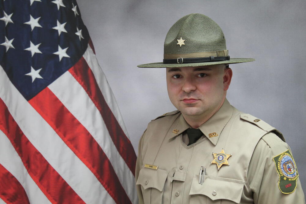 Lt Don Dame pictured in front of an American Flag.