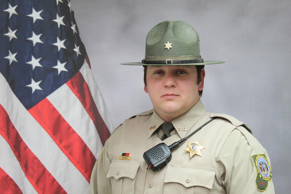 Deputy Josh Anderson pictured in front of an American Flag.