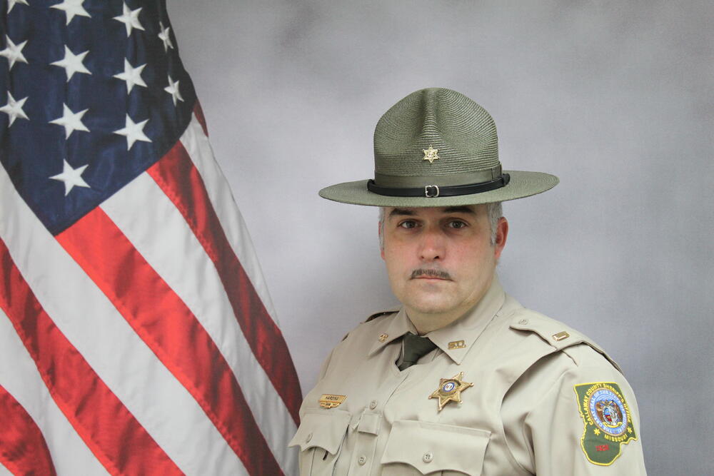 Lt Jeff Harding pictured in front of an American Flag.