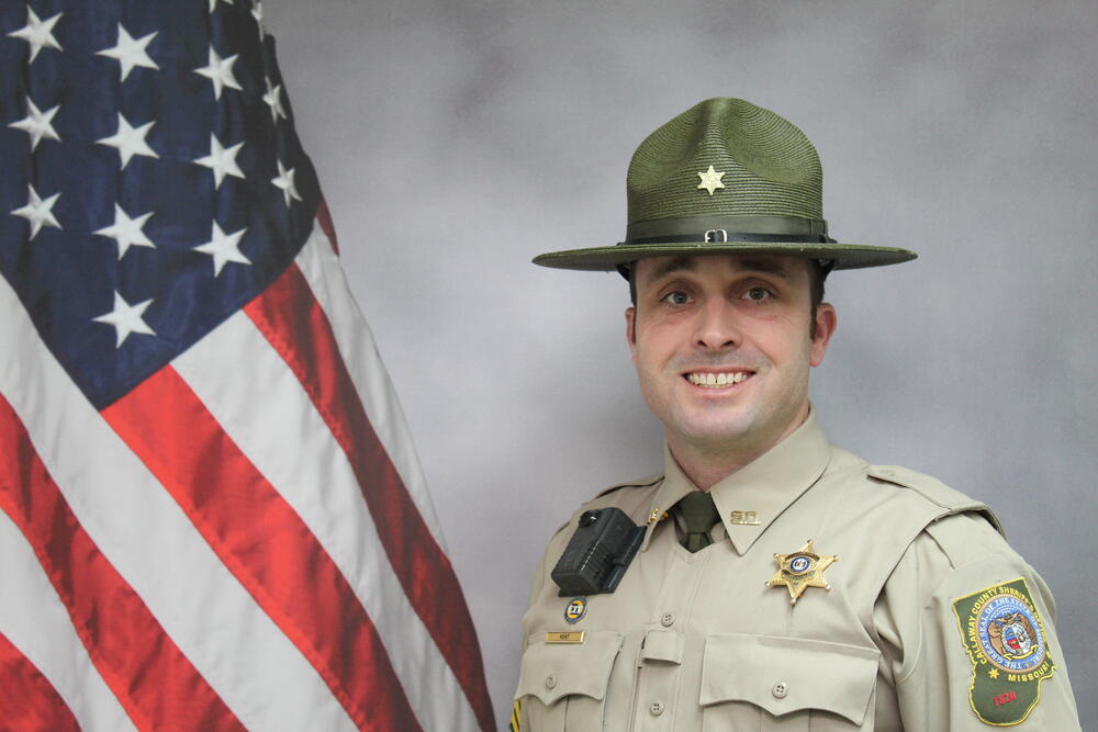 Sgt Jordan Kent pictured in front of an American Flag.