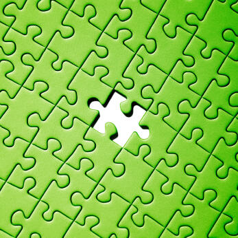 Jigsaw puzzle with one piece missing.