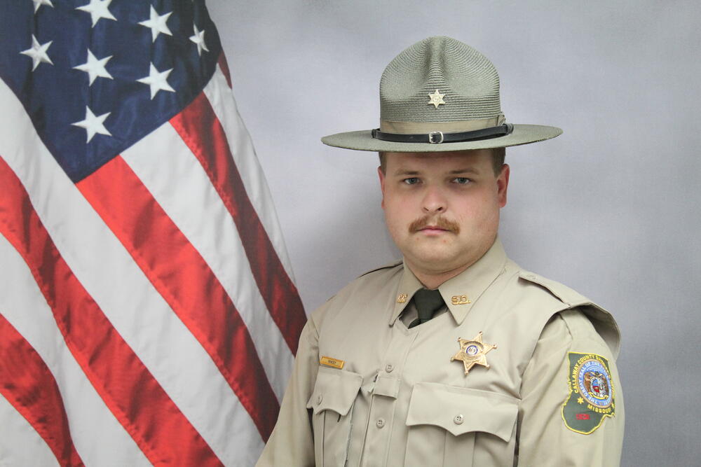 Deputy David Yancey pictured in front of an American Flag.