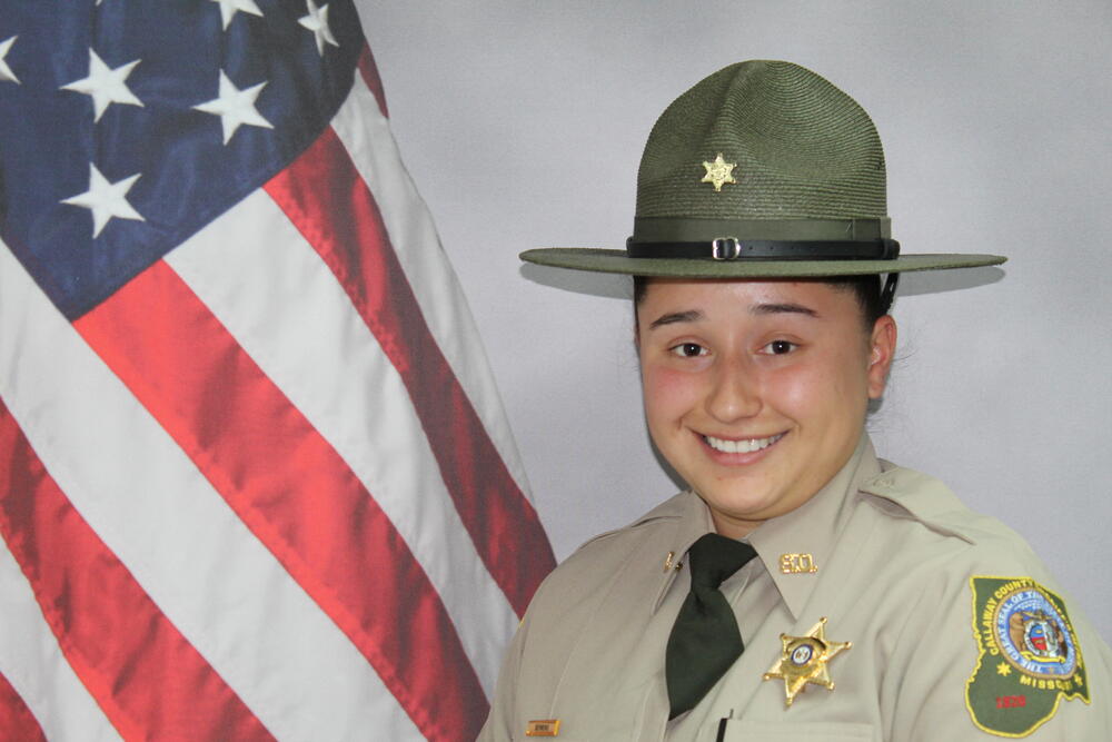 Deputy Celeste Sermeno pictured in front of an American Flag.